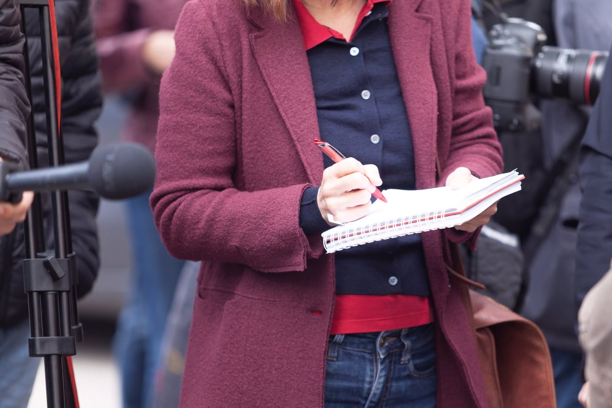 Female reporter at press conference